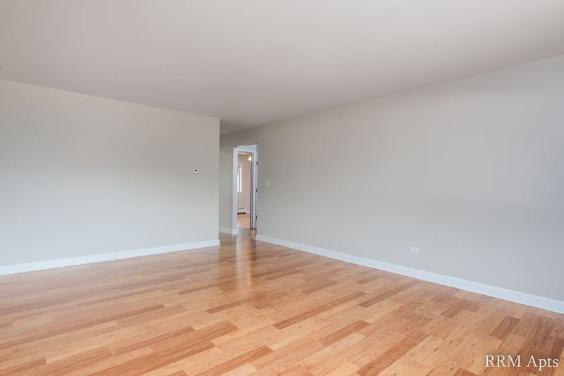 Empty room with wood floor, gray walls and a doorway to the hall, Cook Street apartment 4