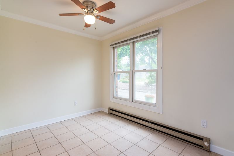 Dining area with tile floor, ceiling fan, one window and baseboard radiator, Depot Road apartment 2