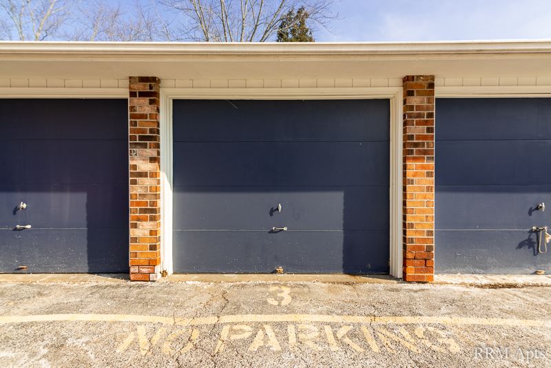 Row of brick garages with dark blue doors, Depot Road