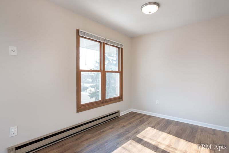 Dining area with window, baseboard heater and wood-look floor, Depot Road apartment 3