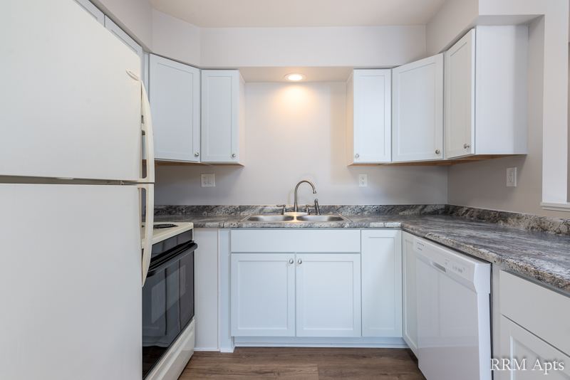 Kitchen with white cabinets, corner sink, dishwasher and electric stove, Depot Road apartment 3