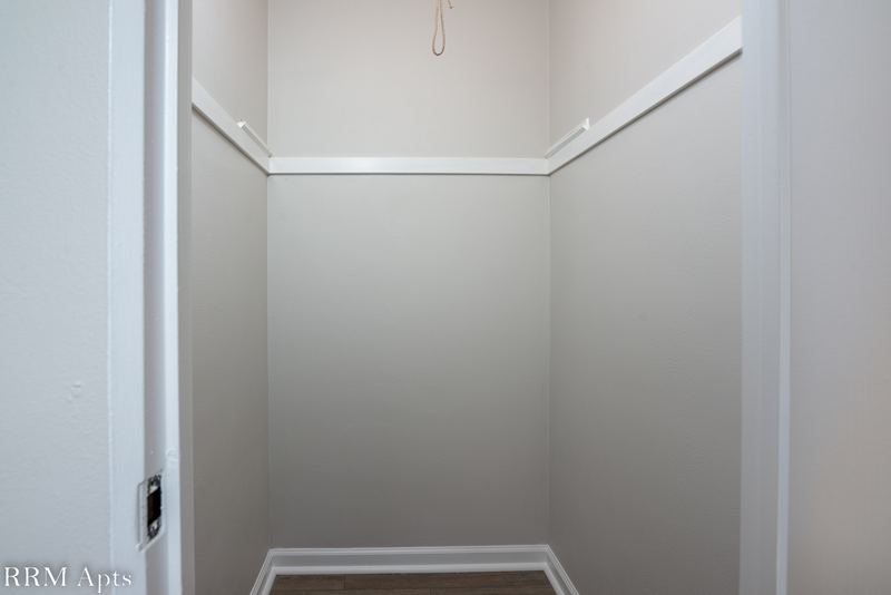 Closet with wire shelving, hanging rod and gray walls, East Park apartment 4