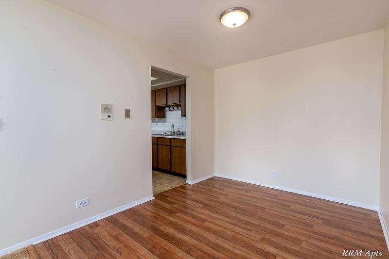 Dining area with wood laminate floor, flush ceiling light and doorway to the kitchen, John Mogg apartment 32985 302