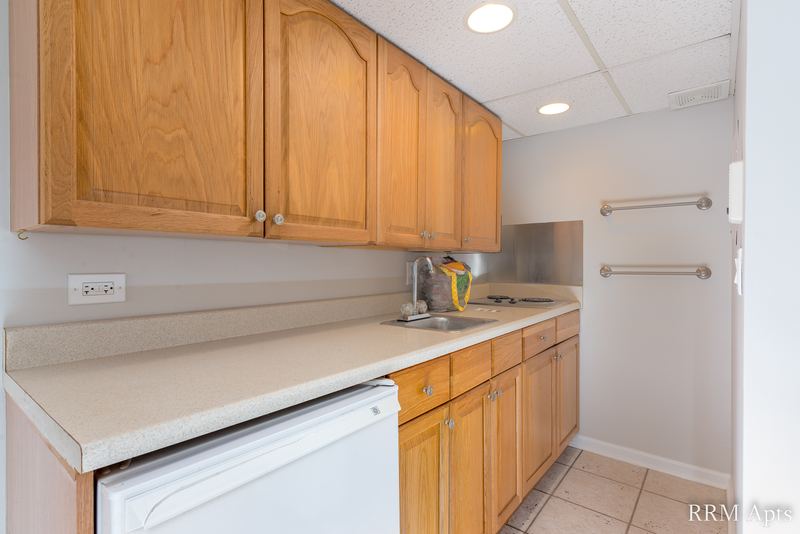Kitchen with wood cabinets, stainless sink, white dishwasher and drop ceiling, Maple Avenue apartment LL4