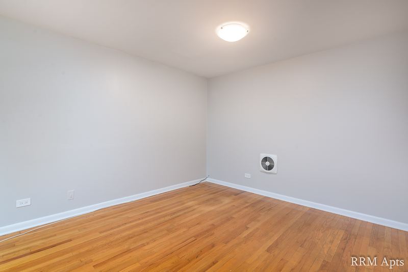 Empty room with wood floor, gray walls, a round wall vent and a ceiling light, Park Avenue apartment 603 103