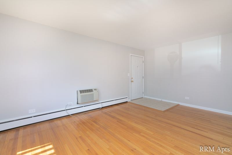 Empty room with wood floor, gray walls, wall air conditioner and a white door, Park Avenue apartment 603 106