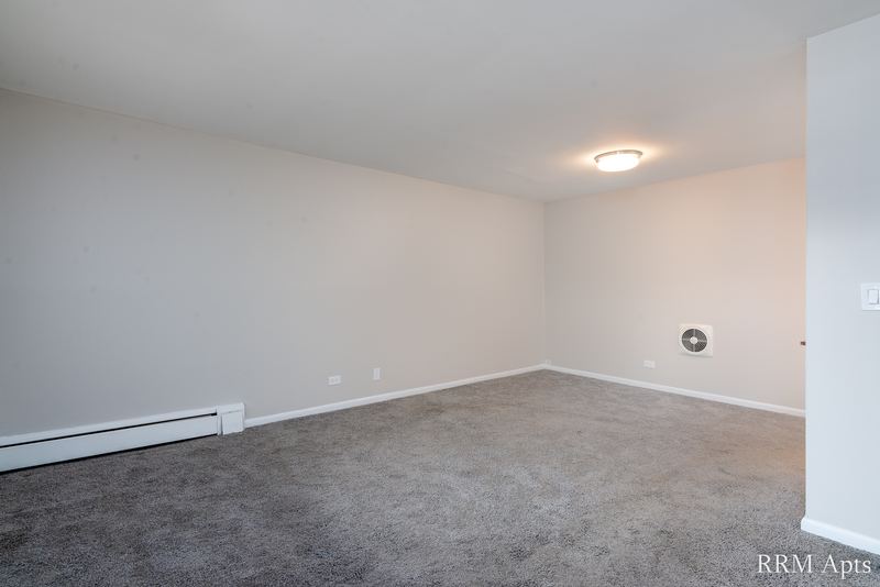 Empty room with gray carpet, gray walls, ceiling light and a round wall vent, Park Avenue apartment 603 205