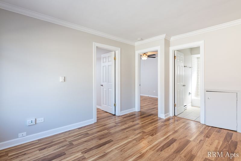 Living room with wood floor, gray walls and doorways to the hallway, bedroom and bathroom, Park West apartment 611A