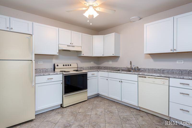 Kitchen with white cabinets, granite-look counter, electric stove, dishwasher and tile floor, Pioneer Court apartment 900-1A