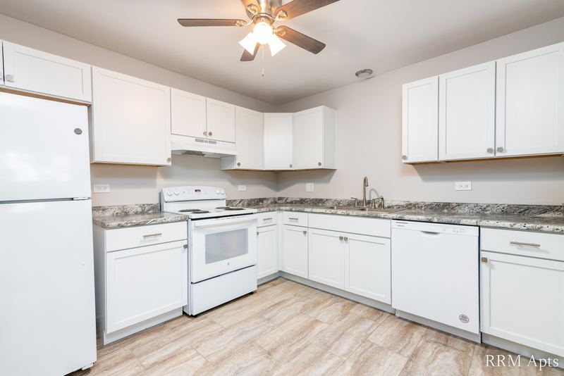 Kitchen with white cabinets, white refrigerator, stove, dishwasher and granite-look counters, Pioneer Court apartment 918-1E