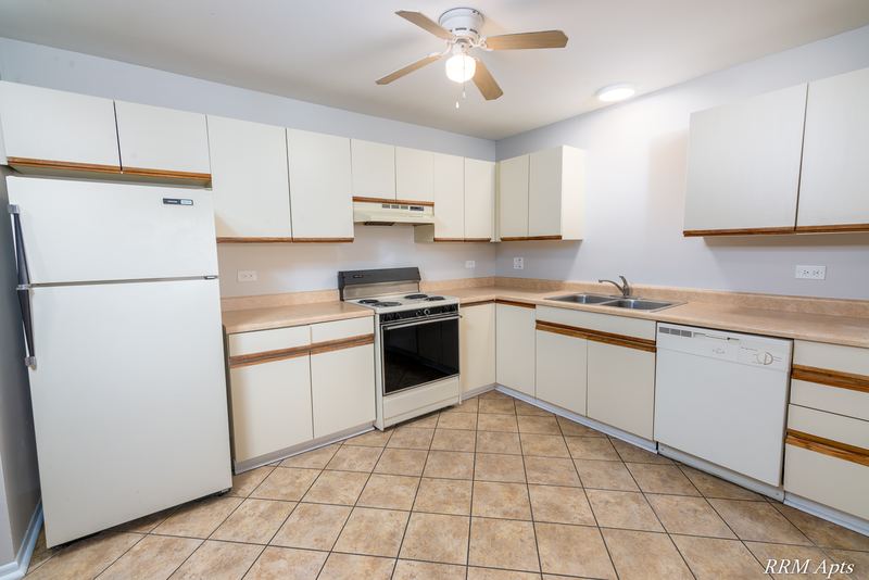 Kitchen with white cabinets, white refrigerator, electric stove, dishwasher and tile floor, Pioneer Court apartment 918-3C
