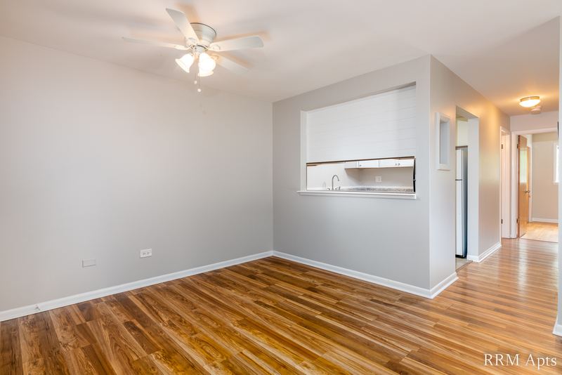 Dining area with wood floor, ceiling fan, kitchen pass-through and a hallway, Slusser Street apartment 1