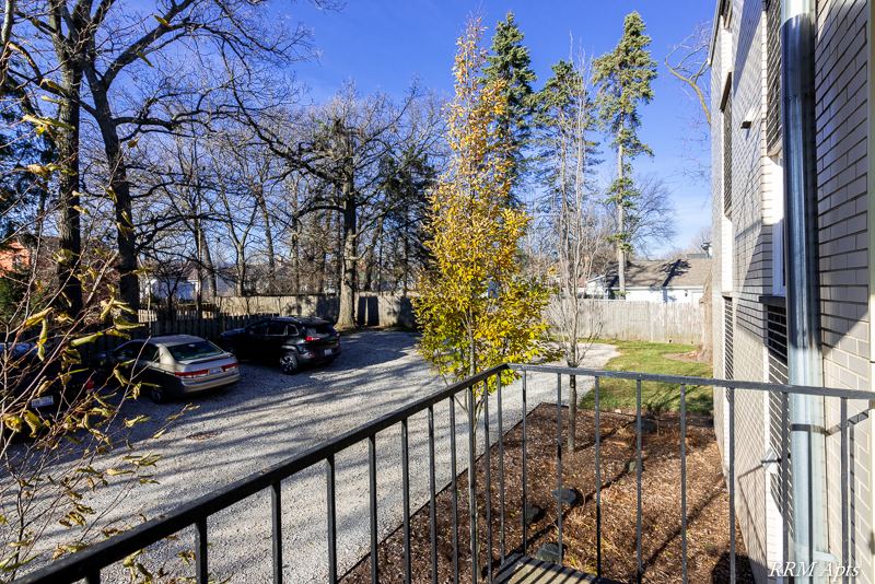 View from the balcony over the parking area and trees, Slusser Street apartment 3