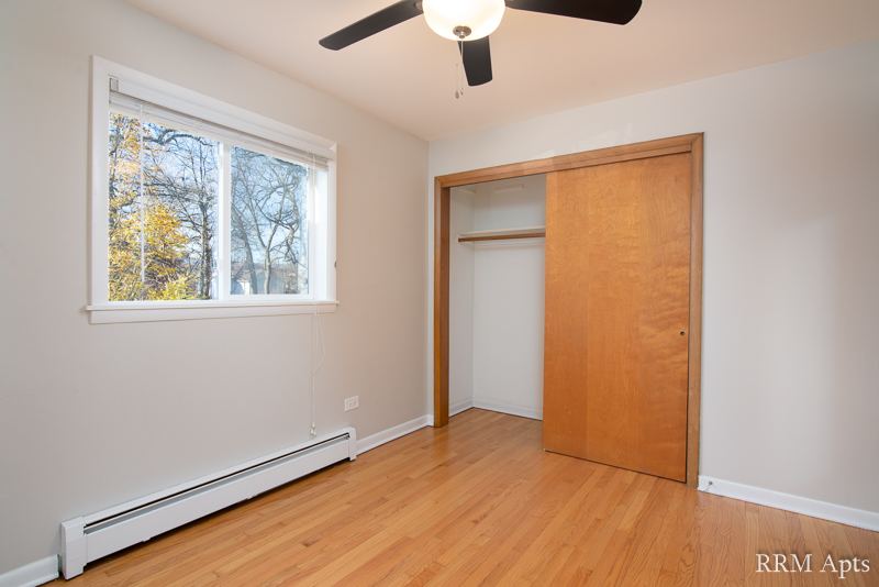 Bedroom with window and closet with sliding wood door, Slusser Street apartment 3