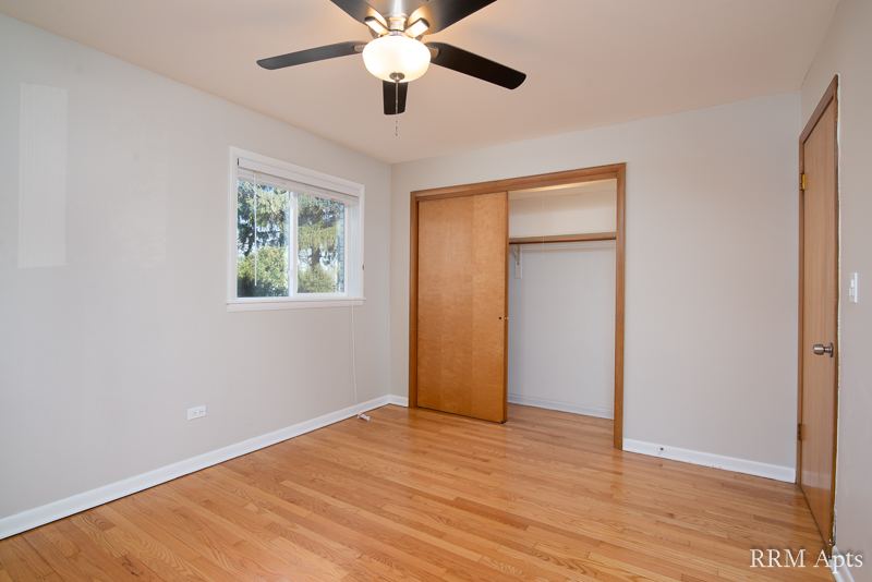 Bedroom with ceiling fan, window and open closet, Slusser Street apartment 3