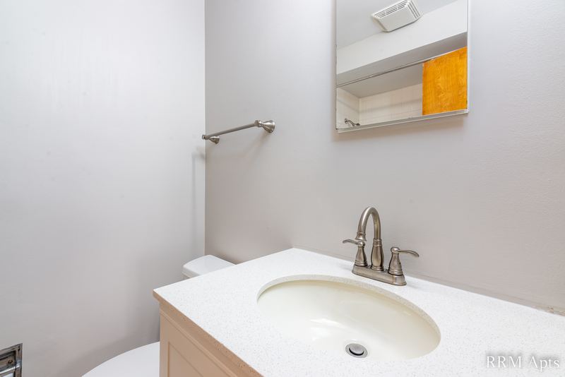 Bathroom with white vanity top, wood cabinet, towel bar and medicine cabinet, Slusser Street apartment 8