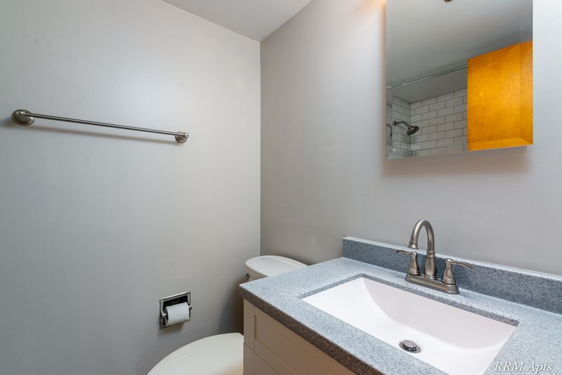 Bathroom with gray granite-look vanity top, white sink, towel bar and medicine cabinet, Slusser Street apartment 9