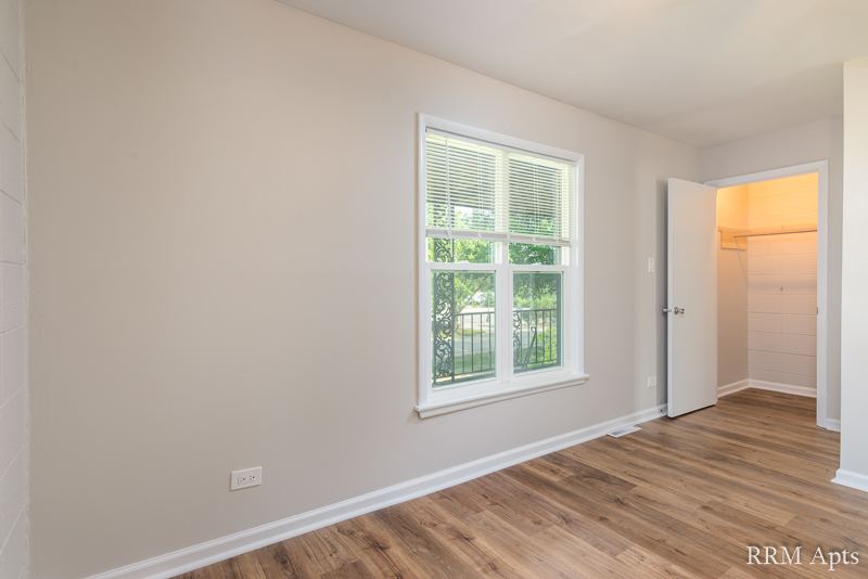 Bedroom with window, wood-look floor and closet, South Slusser apartment 434