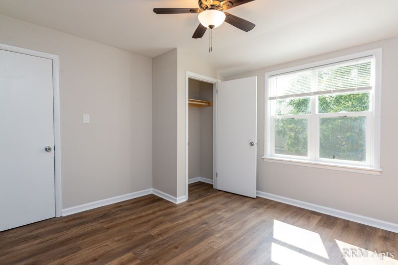 Bedroom with ceiling fan, window and open closet, South Slusser apartment 434