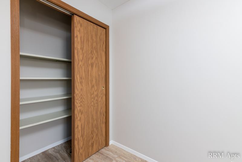 Closet with wood sliding doors and wood shelving, South Slusser apartment 440-5