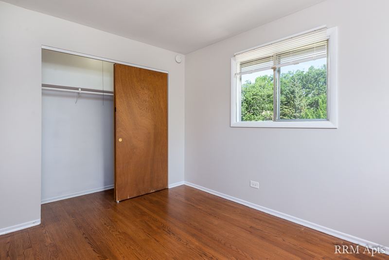 Bedroom with hardwood floor, window and closet with sliding door, Westerfield Place apartment 145D