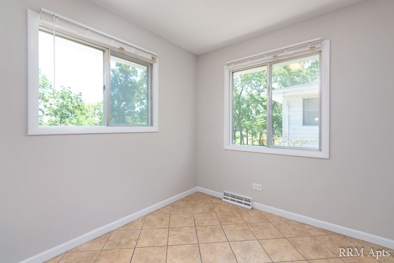 Dining area with two windows and tile floor, Westerfield Place apartment 145D