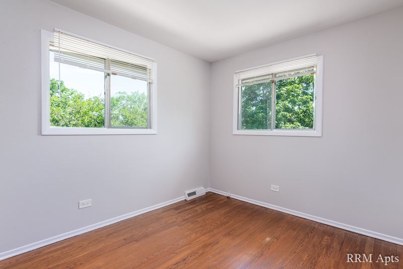 Bedroom with two windows and hardwood floor, Westerfield Place apartment 145D
