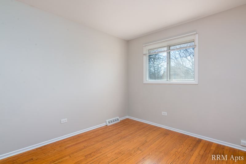 Bedroom with wood floor, window and baseboard heater, Westerfield Place apartment 149-C