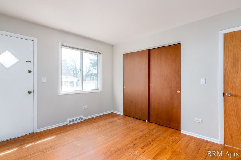 Entry with wood floor, white front door, window and closet with wood doors, Westerfield Place apartment 149-C